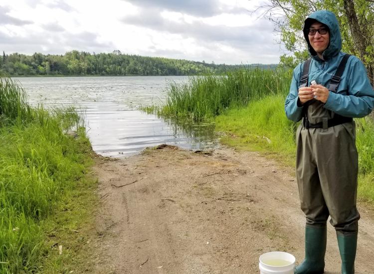 Ben Ma by a river and dressed to sample water.