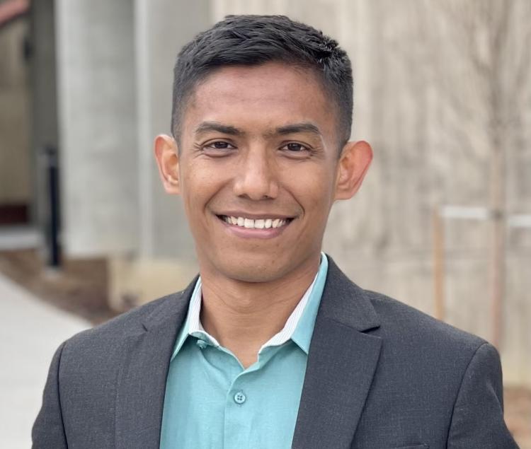 Ilham Siddiq in a suit jacket and a casual shirt underneath.