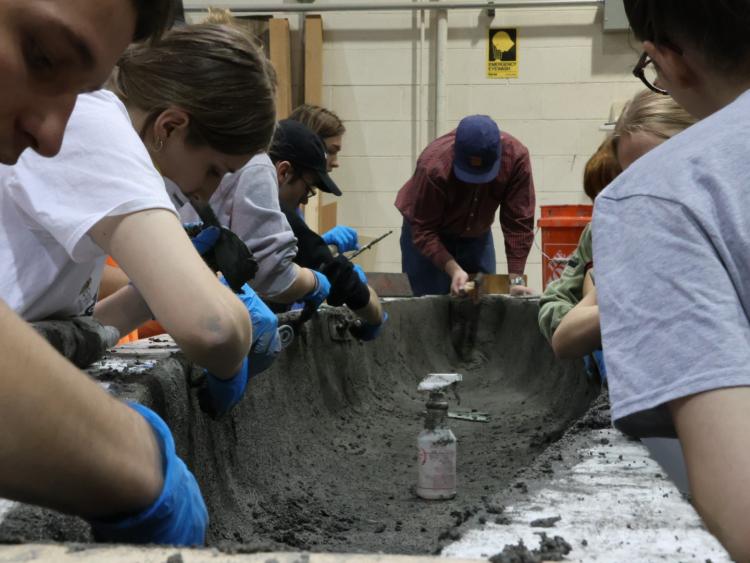 Concrete Canoe team adds the final layer on "Pour Day."