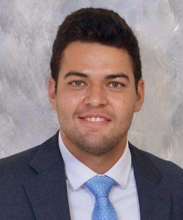 Daniel Donado-Quintero in a suit and tie.