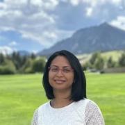 Aditi Bhaskar with the Flatirons blurred in the background.