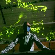 John Crimaldi watches as green laser light illuminates plumes in his lab's test flume. 