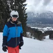 Ian Lummis in ski clothes with a winter background.