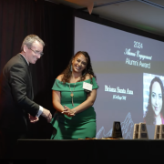 Briana Santa Ana receives her award from Dean Keith Molenaar.