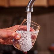 Pouring water into a glass.