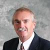Donald R Clark in a suit. Clark has a mustache.