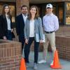 Cristina Torres-Machi’s group stands in front of the corner of a brick building.