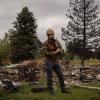 Brad Wham in a hard hat in a neighborhood burnt by the Marshall Fire