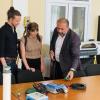 Carlo Salvinelli and Kat Demaree reviewing equipment with a representative from Armenia.