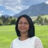 Aditi Bhaskar with the Flatirons blurred behind her.