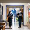 CU Boulder alumna Halle Sago, left, and undergraduate student Ricardo Reyes, right, visit High Peaks Elementary School in Boulder, Colorado, to monitor air quality. (Credit: Glenn Asakawa/CU Boulder)