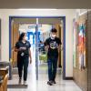 CU Boulder alumna Halle Sago, left, and undergraduate student Ricardo Reyes, right, visit High Peaks Elementary School in Boulder, Colorado, to monitor air quality.