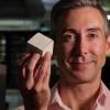 Wil Srubar holds a concrete block.