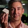 Wil Srubar holds a sample cube of concrete that contains biogenic limestone produced by calcifying macro- and microalgae.
