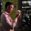 Wil Srubar looking at a block of his algae-derived concrete.