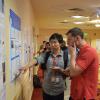 Shang Liu discusses his research with a conference attendee