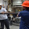 Two researchers in hard hats work with testing equipment in the CIEST lab