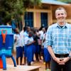 Evan Thomas stands next to one of his filtration devices in Africa