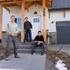 Matt Morris and the two students who helped build his home in front of his newly-built home