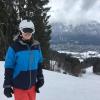 Ian Lummis in ski clothes with a winter background.