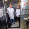 Professor Mark Hernandez and doctoral graduate Marina Nieto-Caballero stand inside the 10-cubic-meters bioaerosol chamber used to study live airborne coronavirus persistence in the Environmental Engineering disinfection laboratory at the Sustainability, Energy and Environment Complex (SEEC). Photo by Patrick Campbell/University of Colorado.
