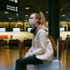 Woman sitting on a luggage at the airport