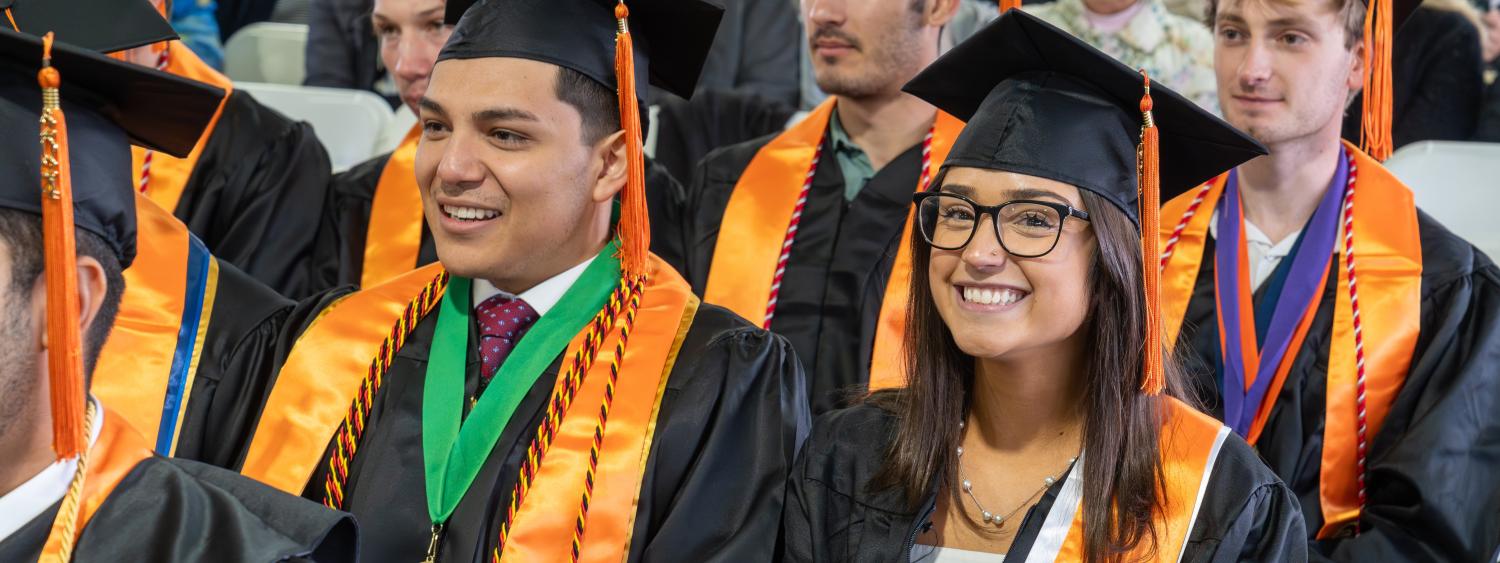 Graduating master's students sitting in regalia