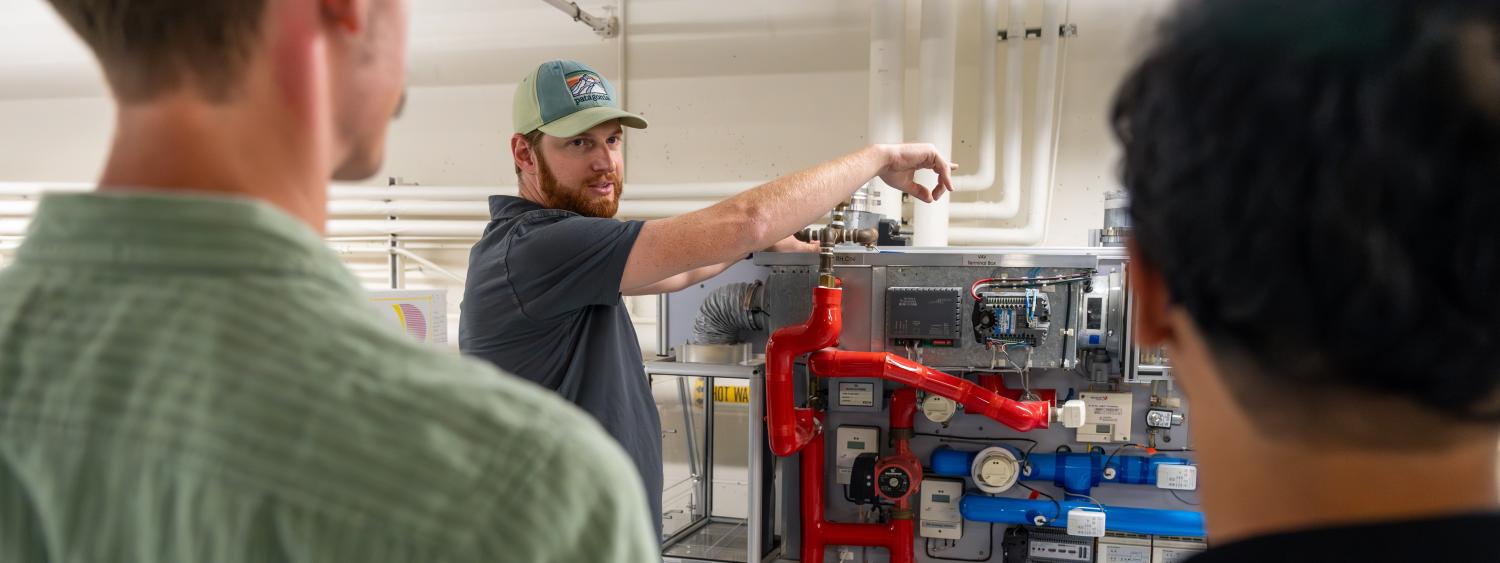 Nick demonstrates a piece of equipment in the Larson Lab