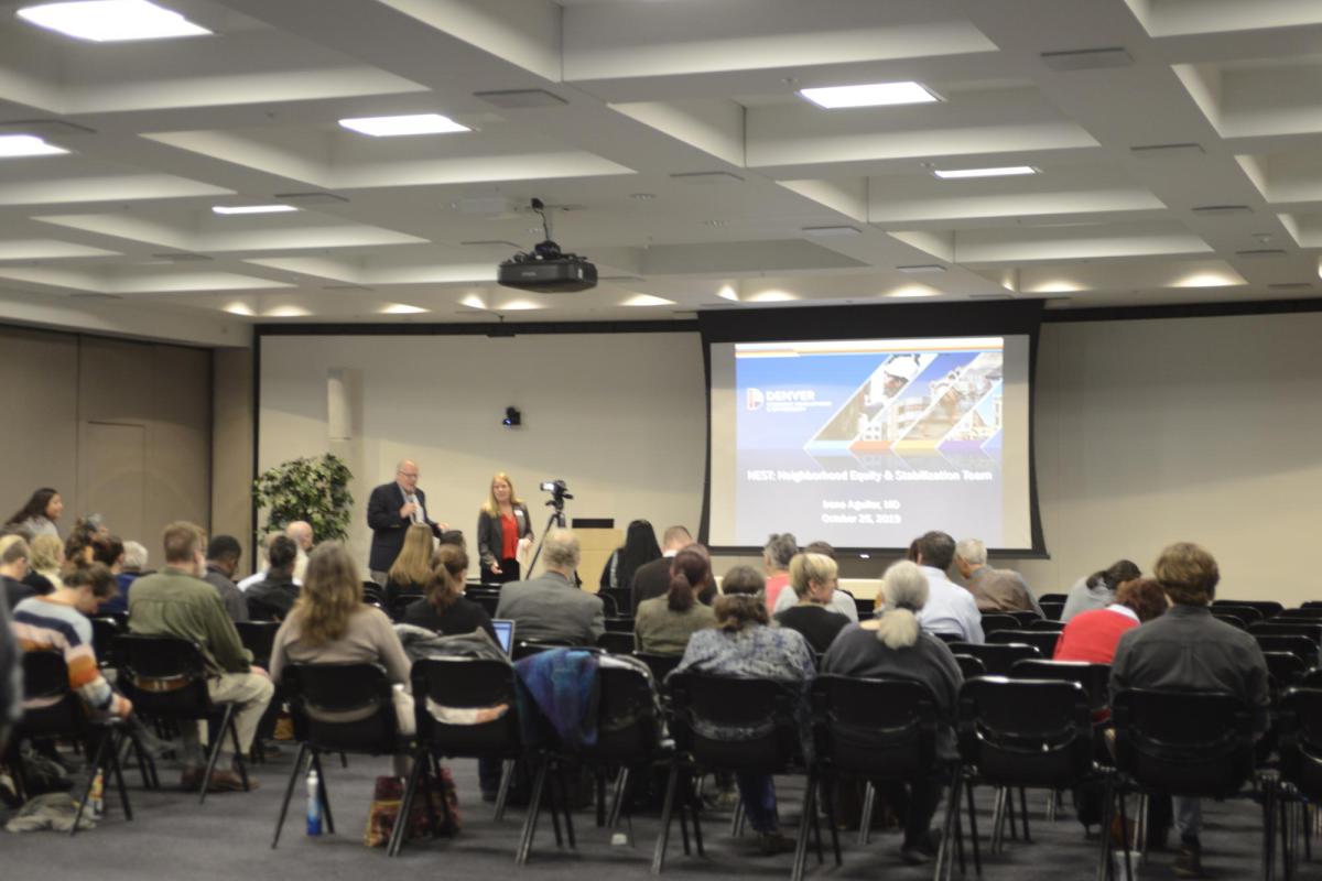Speaker and crowd at Squeezed Out Conference