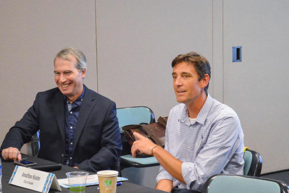 Paul Chinowsky, director of CU Boulder's Program in Environmental Design, left, and Jonathan Koehn, regional sustainability coordinator with the city of Boulder, right, interact during the climate change panel. Photo by Sarah Manning