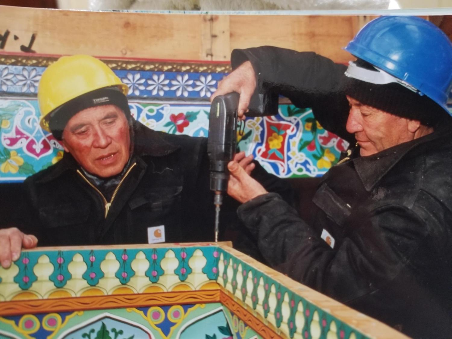 Mirpulat Mirakhmatov grandfather of Marufjon (Maruf) Mirakhmatov watches while another worker drills during the construction of the Boulder Dushanbe Teahouse in 1997 or 1998.