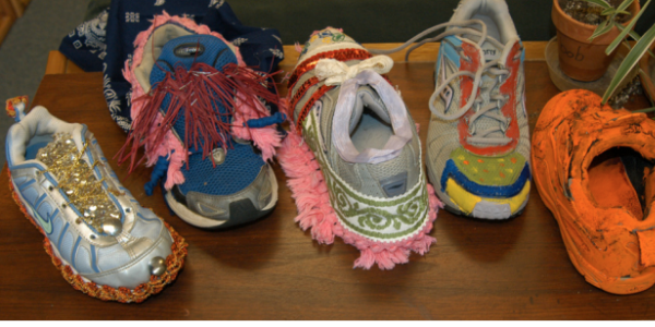 Decorated sneakers representing ecological footprints. 