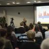 Speaker does a presentation at the Squeezed-Out conference