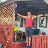 Dave Weil with his hands up on the porch in front of his mobile home.