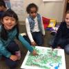 Girls point to a map they designed