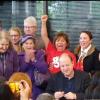Governor Polis signs a bill surrounded by mobile home activists celebrating