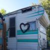 RV with a heart on it next to a nice wooden fence.