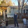 Peggy Kuhn stands in her back yard with her manufactured home behind her.