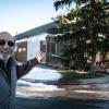 Tom Sundro Lewis points to his home