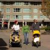 Parents walking with kids in strollers in Vancouver Park