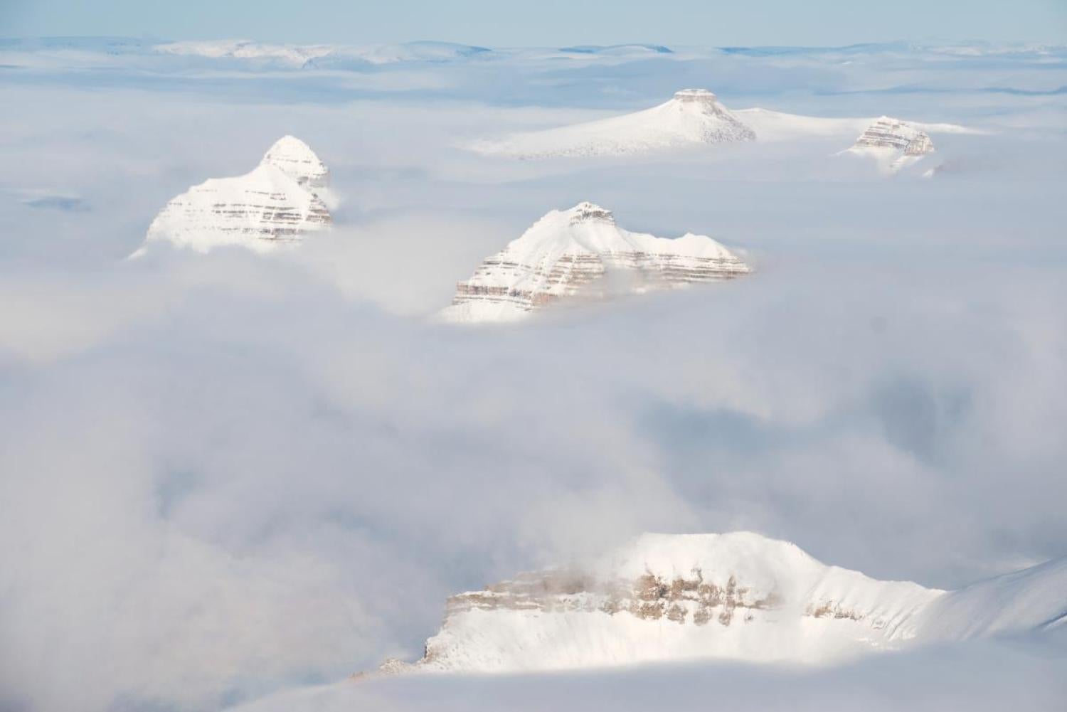 After Longyearbyen, the Arctic Lenses team flew to the research station of Ny-Älesund. Snow-draped mountains peeked up above the clouds as the small twin-engine plane descended toward the runway.
