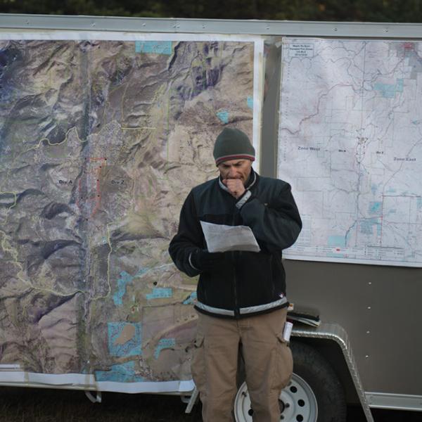 Heil Ranch map displayed on the fire fighters equipment trailer and a fire fighter looking at a map
