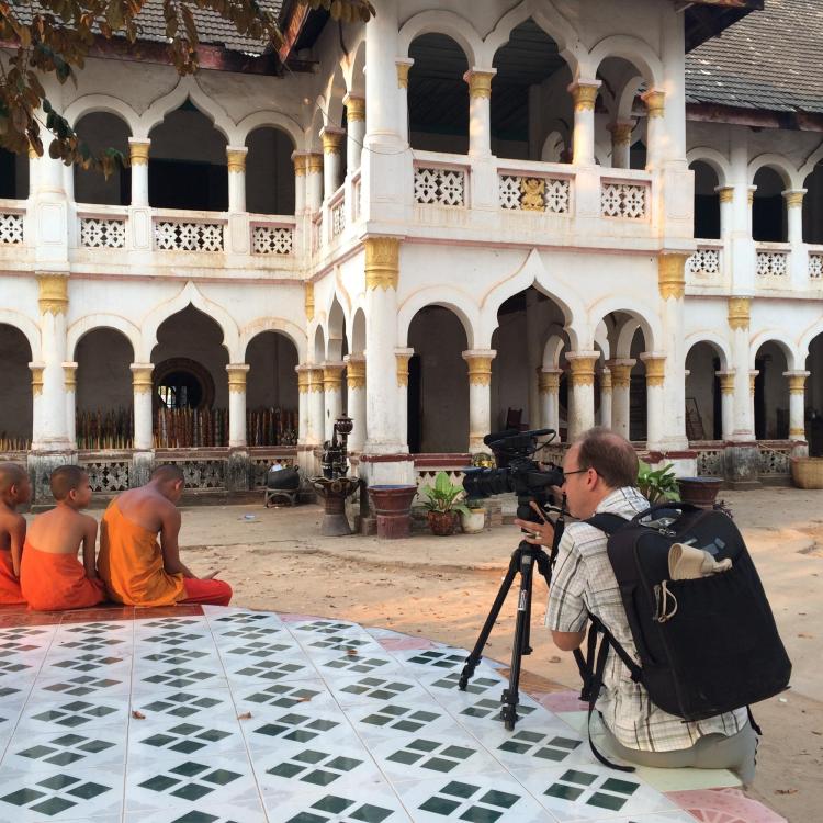Director Jerry Redfern films a group of novice monks at a temple in southern Laos.