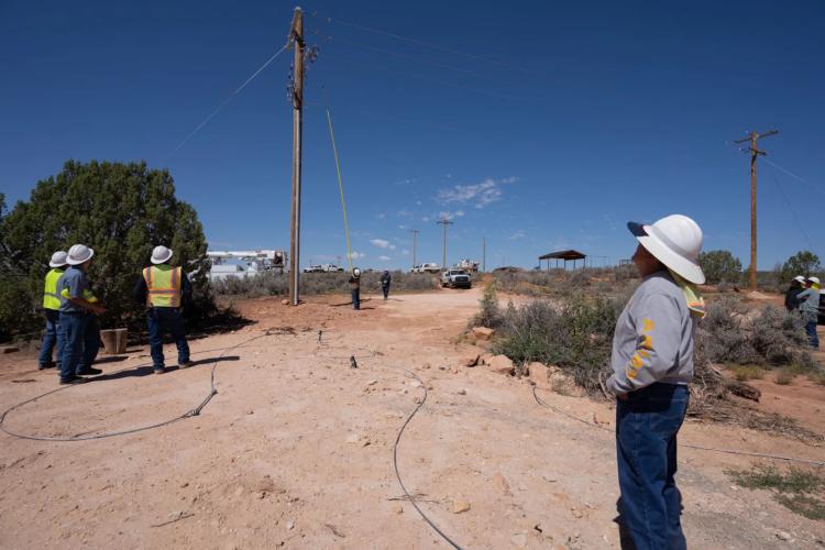 A Navajo Tribal Utility Authority lineman uses a pole to flip a circuit switch on Sept. 1 in Westwater, Utah, connecting the Navajo community to the electrical grid for the first time. (Photos by Shannon Mullane, Special to The Colorado Sun)