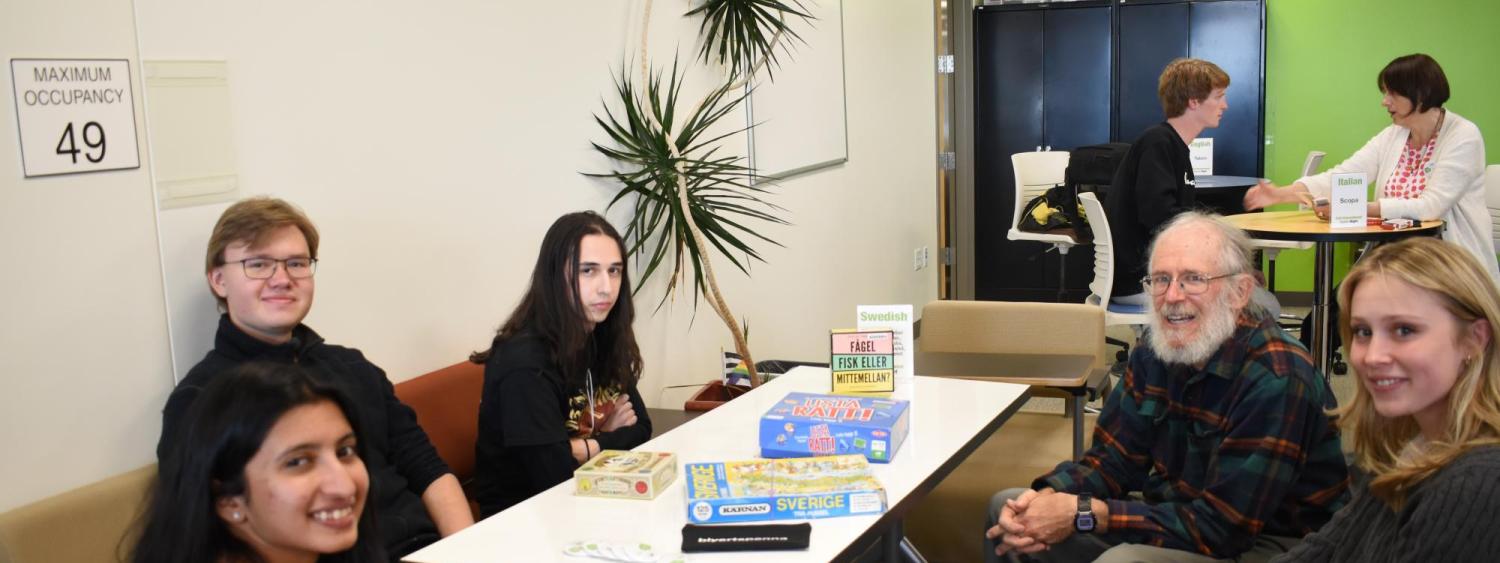 Students pose around table with Swedish games