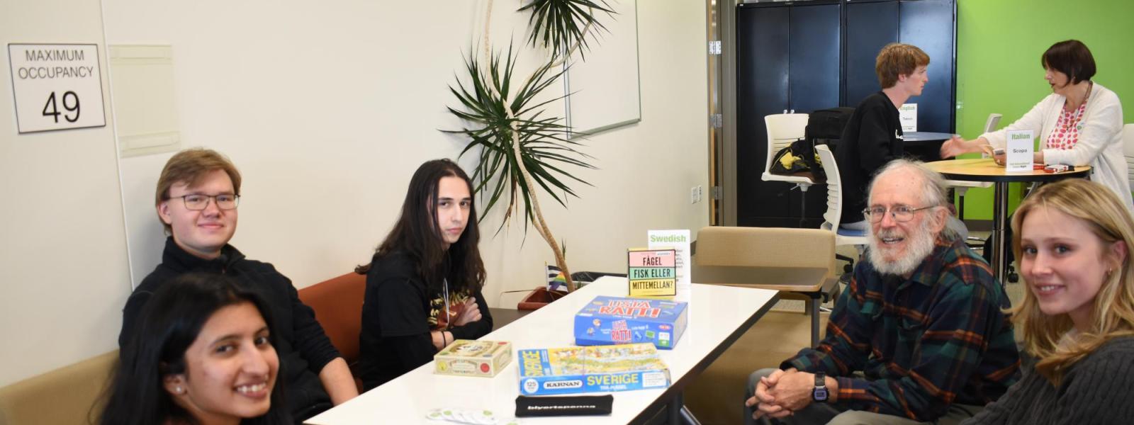 Students pose around table with Swedish games