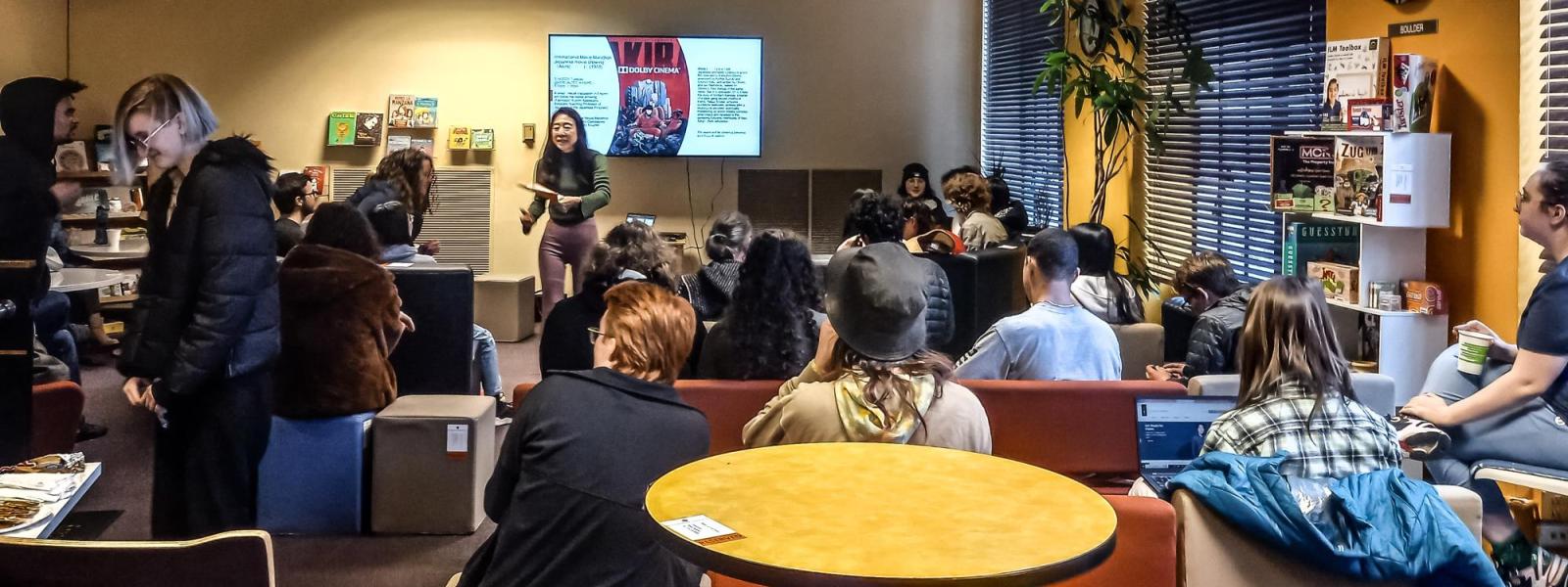 Students gathered to watch instructor present before film screening