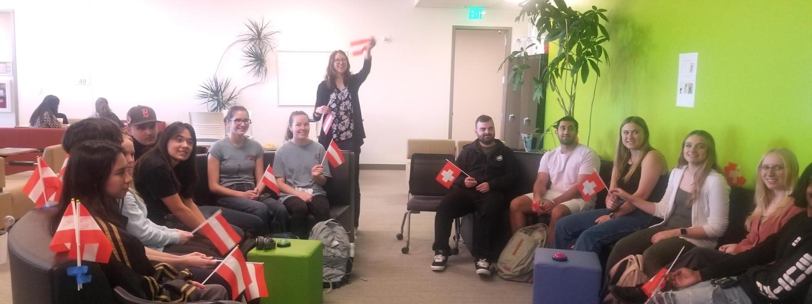 Group of students holding Swiss and Austrian flags