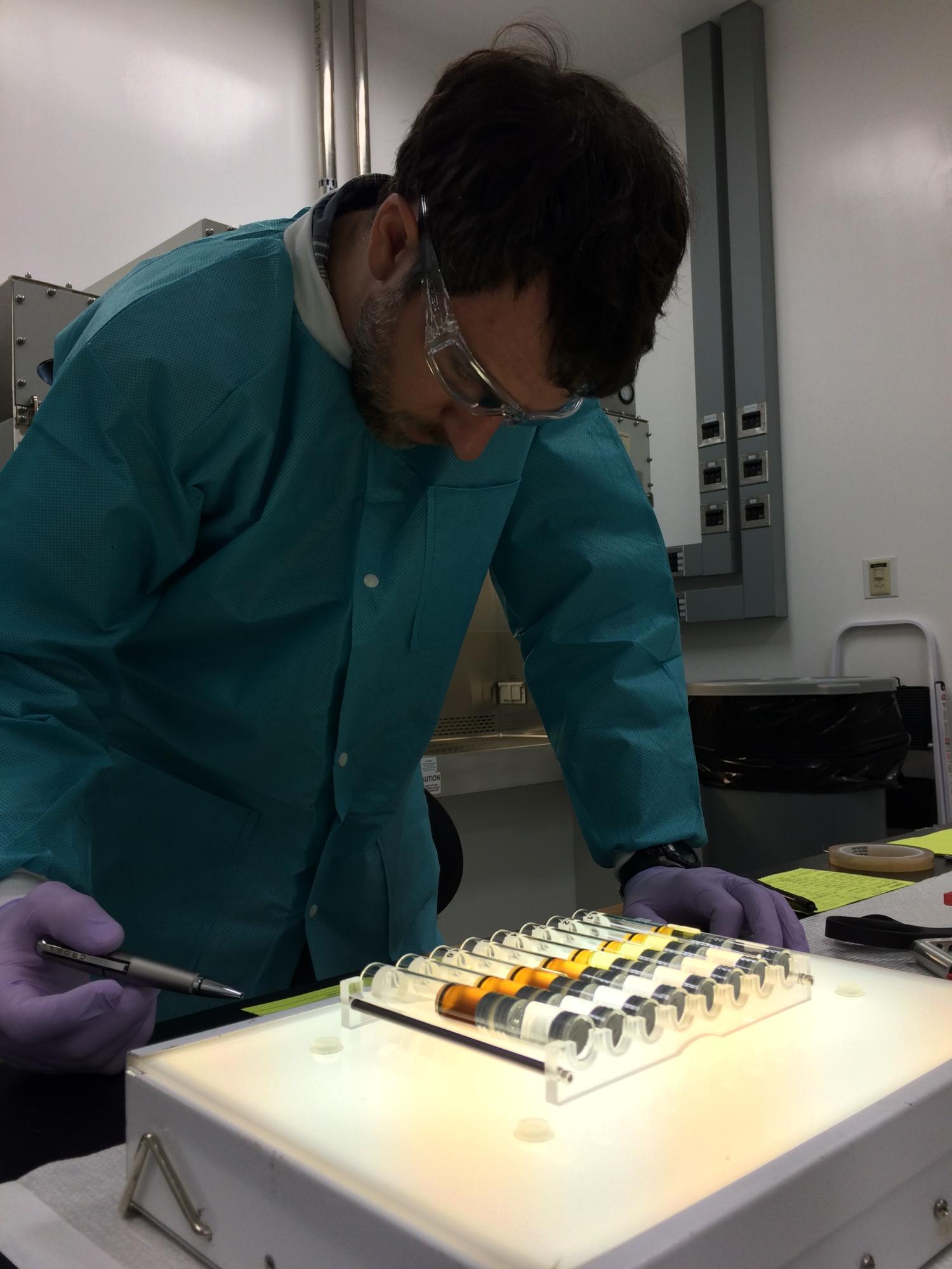 BioServe engineering personnel examing a set of FPAs prior to flight