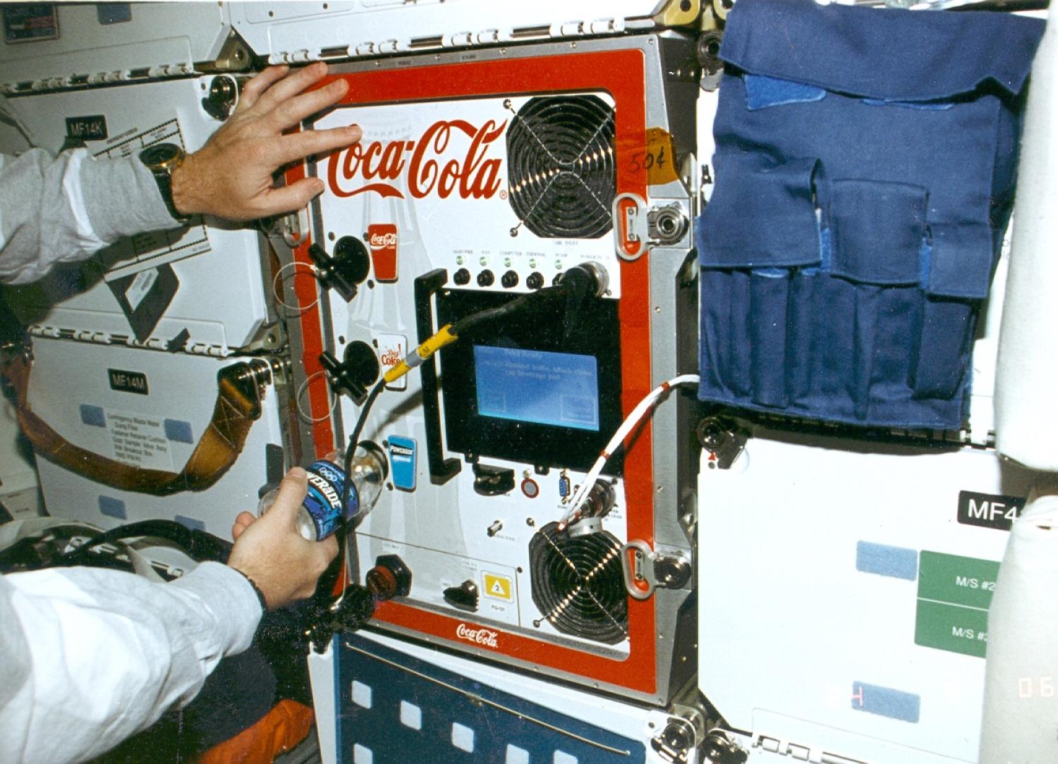 FGBA-2 being used by an astronaut to dispense Powerade on STS-77